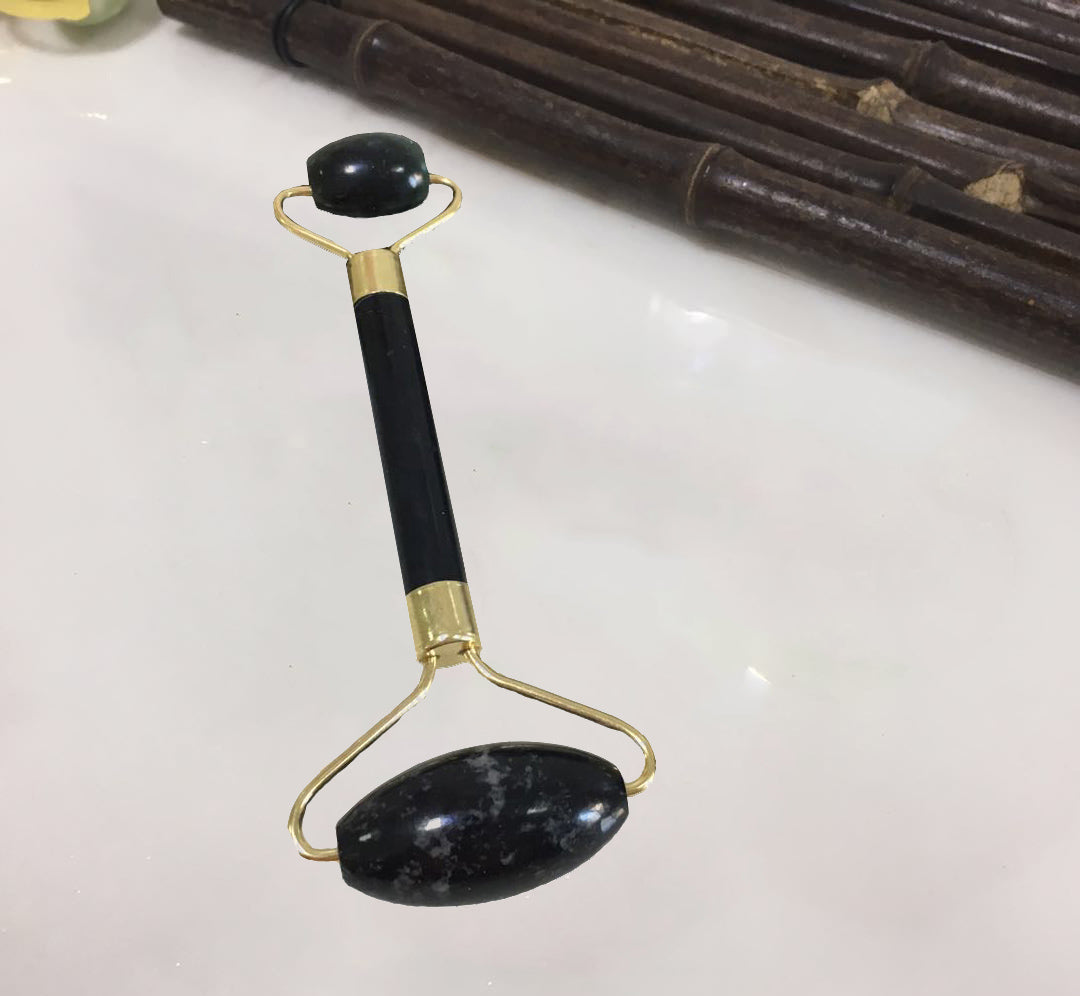 Jade roller and gua sha in use